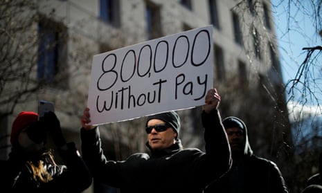 A demonstrator holds a sign at the “Rally to End the Shutdown” in Washington, DC.