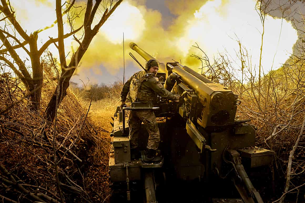 Ukrainian service personnel fire a self-propelled howitzer
