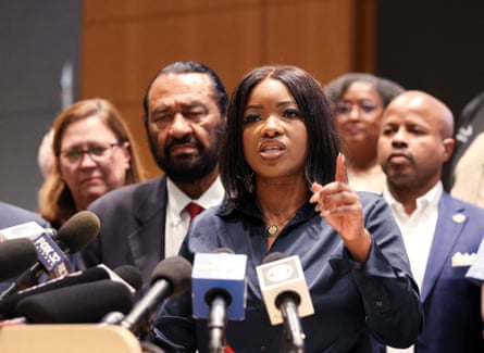 Woman points finger behind microphone
