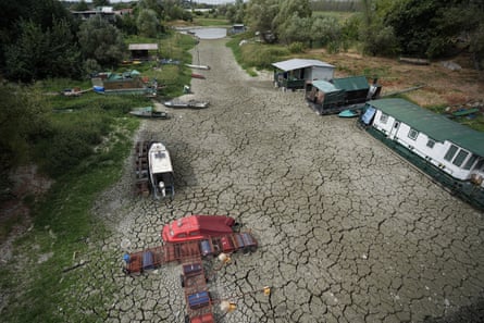 Boats sit on dry, cracked ground by the Danube River in Petrovaradin, Serbia.