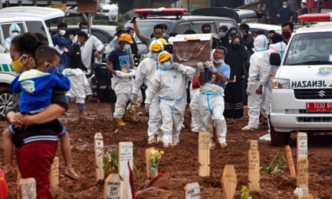 Funeral workers prepare to bury Covid victims at the Pedurenan public cemetery in Bekasi, West Java.
