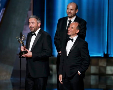 Simon Blackwell (L) accepts the Emmy for outstanding writing for a comedy series with Tony Roche and Armando Iannucci, for their work on Veep in 2015.