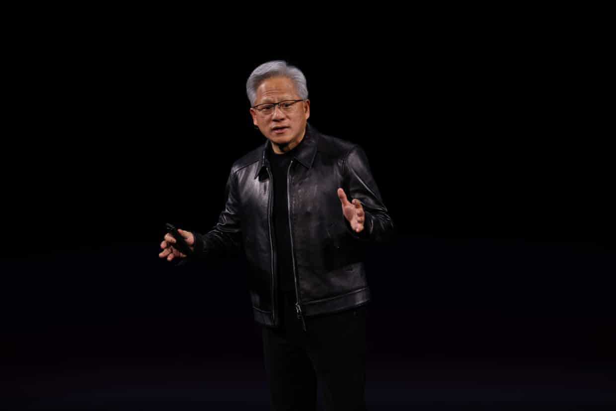 An older man in a leather jacket speaks