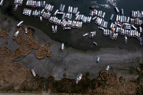 Aerial shot of boats, some stranded on land by the receding waters.