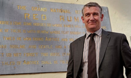 Donald McCain, trainer of Minella Trump, in front of the Red Rum plaque in the old winner’s enclosure at Aintree.