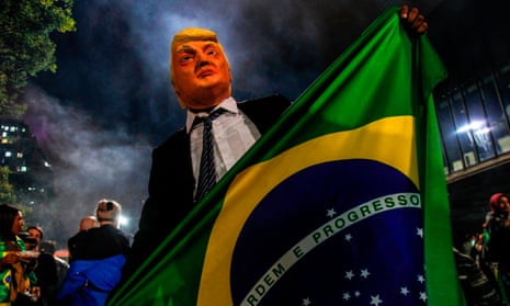 A supporter  presidential election winner Jair Bolsonaro wears a mask of Donald Trump