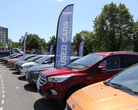 cars lined up at a used-car showroom