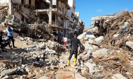 Members of Libyan Red Crescent work in an area affected by flooding in Derna