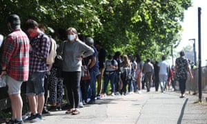 A queue of people waiting for vaccine outside Belmont health centre in Harrow, London