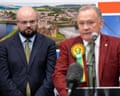 Reform UK's Llŷr Powell (left) looks on as Plaid Cymru's Lindsay Whittle makes a speech after being declared winner for the Caerphilly Senedd byelection on 24 October.