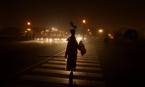 A woman crosses the road in New Delhi.