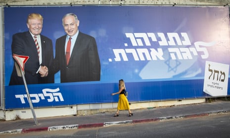 A woman walks by an election campaign billboard for the Likud party that shows Israeli Prime Minister Benjamin Netanyahu, right, and US President Donald Trump, in Tel Aviv, Israel, Sunday, Sept 15, 2019. Hebrew on billboard reads “Netanyahu, in another league.” (AP Photo/Oded Balilty)