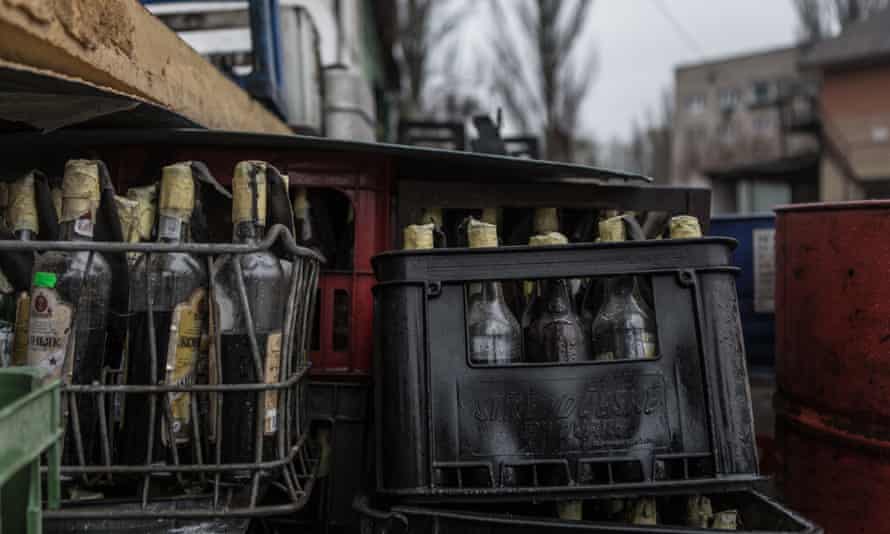 A photo shows empty bottles collected for the production of Molotov cocktails at a garden of a furniture company converted into a war manufacturing centre.