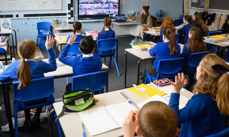 Children attend an online assembly at Gamlingay village primary school. Fewer aerosols in enclosed space such as classrooms could mean other people are less likely to be infected if they also occupy those spaces.