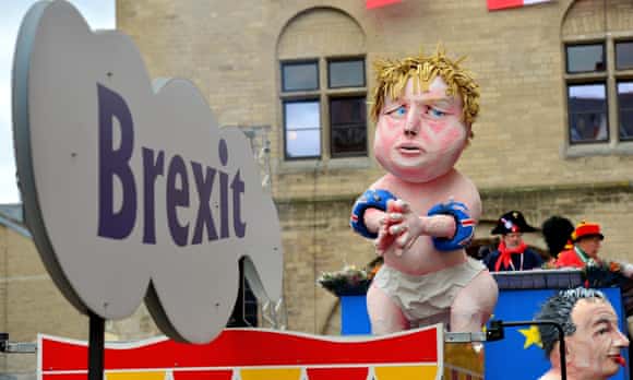 Revellers celebrate on a float carrying an effigy of Boris Johnson during a carnival parade in Cologne.
