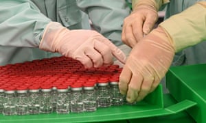 Lab technicians handle vials during tests for the production of the University of Oxford’s Covid-19 vaccine candidate