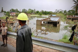 Locals stand near the flooded village of Tica, central Mozambique.