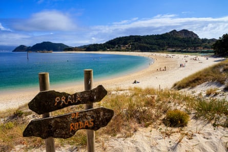 curved beach and sea and signs in Spain