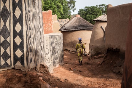 A woman walks in the streets of Tiébélé.