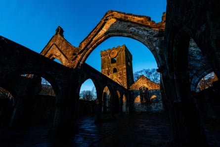 Sunlight illuminates the ruins of St Thomas a Becket Church in Heptonstall at dusk