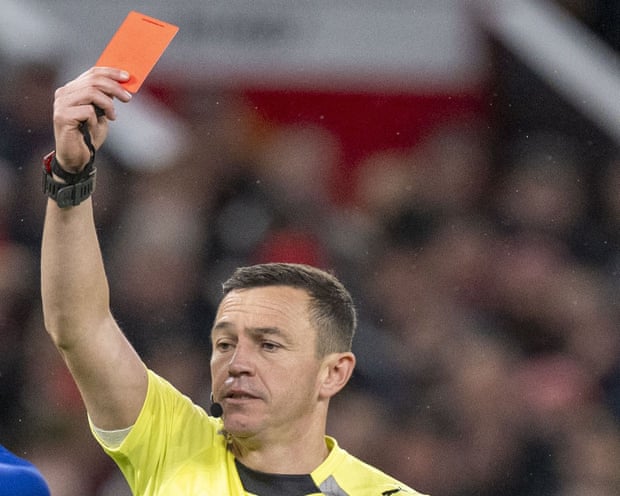 A referee shows the red card