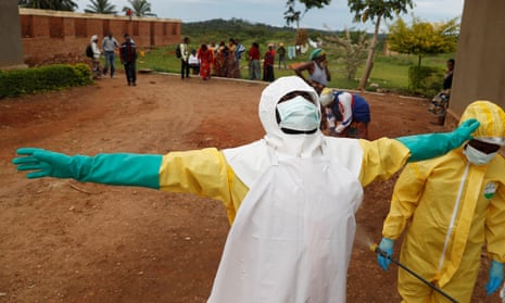 A healthcare worker is decontaminated in Beni, one of several areas of Kivu province hit by Ebola