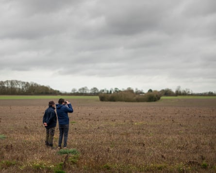 Patrick Barkham looking through binoculars with Collin in the fields