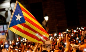 People hold candles at a Catalan pro-independence demonstration in Barcelona.