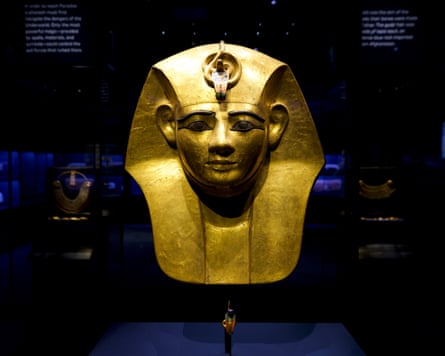 A gold mask in a display case