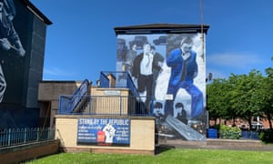 One of the Bogside murals sharing a space with a modern republican poster.