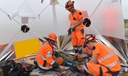 Workers in high-vis clothing trying to reconnect a signal box to the track in technical ducts near Chartres, France, on Friday.