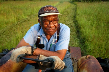 Eddie Cotton, 82, Hermanville, MS, clears a field for a fall crop of hay, using a 40-year-old tractor. He is among thousands of Black farmers denied federal loans in past years. ‘They took away my ability to provide for my family,’ he says.