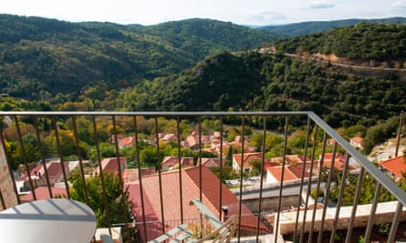 The village is surrounded by tree-cladded hills.