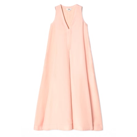 A peach A-line maxidress from cos. The dress is sleeveless with a deep v-neck.