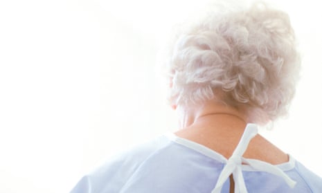 Elderly patient wearing a hospital robe.