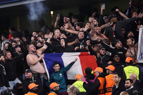 Paris St Germain fans celebrate Senny Mayulu scoring their third goal.