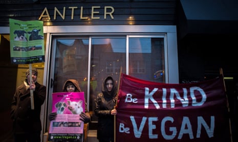 Vegan protesters gather outside of the Antler restaurant in Toronto on Saturday, March 31, 2018. 