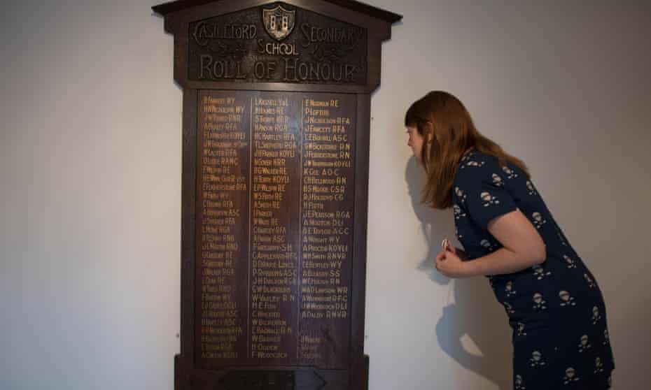 An employee at the Henry Moore Foundation looks at the roll of honour board