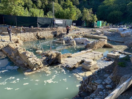 Partly submerged remains of ancient structure, with bottom of pillar visible.