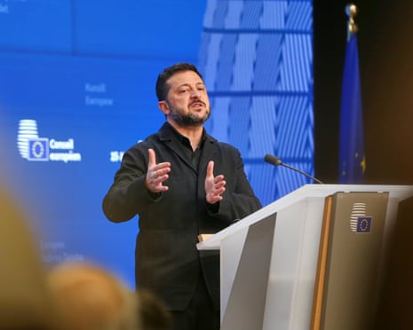 Volodymyr Zelenskyy gestures while speaking at a podium during an EU press conference