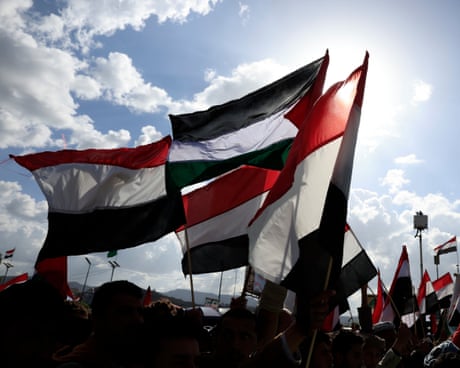 Houthi supporters wave Yemeni and Palestinian flags in Sana'a