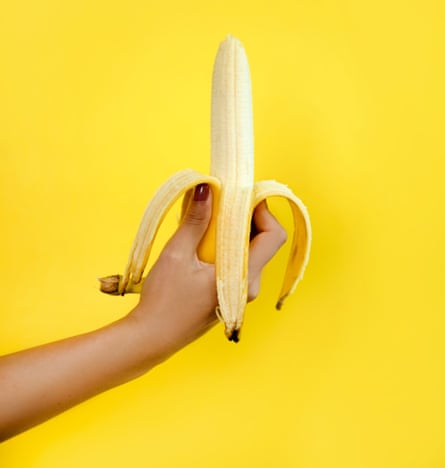 Woman’s hand holding banana
