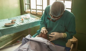 A surgeon operates on a young boy with trachoma in Nigeria.