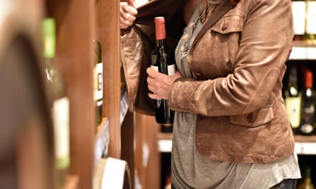 A bottle of wine is hidden away inside a leather jacket
