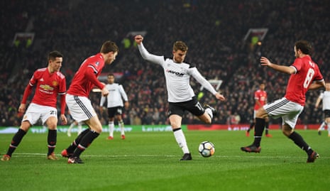 Derby’s Sam Winnall is surrounded by United players.