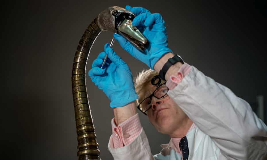 Horologist Matthew Read reassembles the mechanical swan in a process expected to take more than four days to complete.