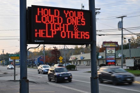 Vehicles drive past a sign in Lewiston, Maine, on Friday in the aftermath of a mass shooting.