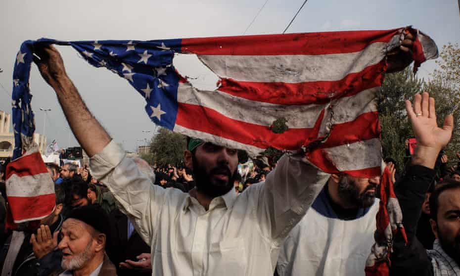 Iranian protesters deface US flags following the killing of Qassem Suleimani in Baghdad, Tehran, January 2020