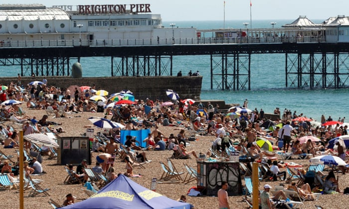 People enjoying the sunny weather at the beach in Brighton on Friday.