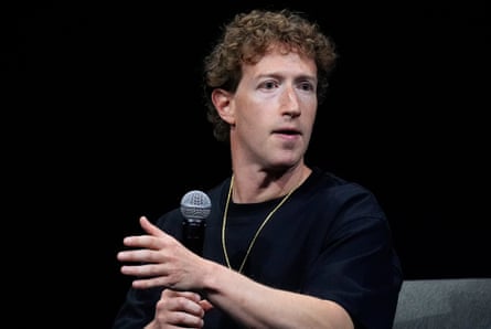 person wearing black shirt gestures while holding microphone